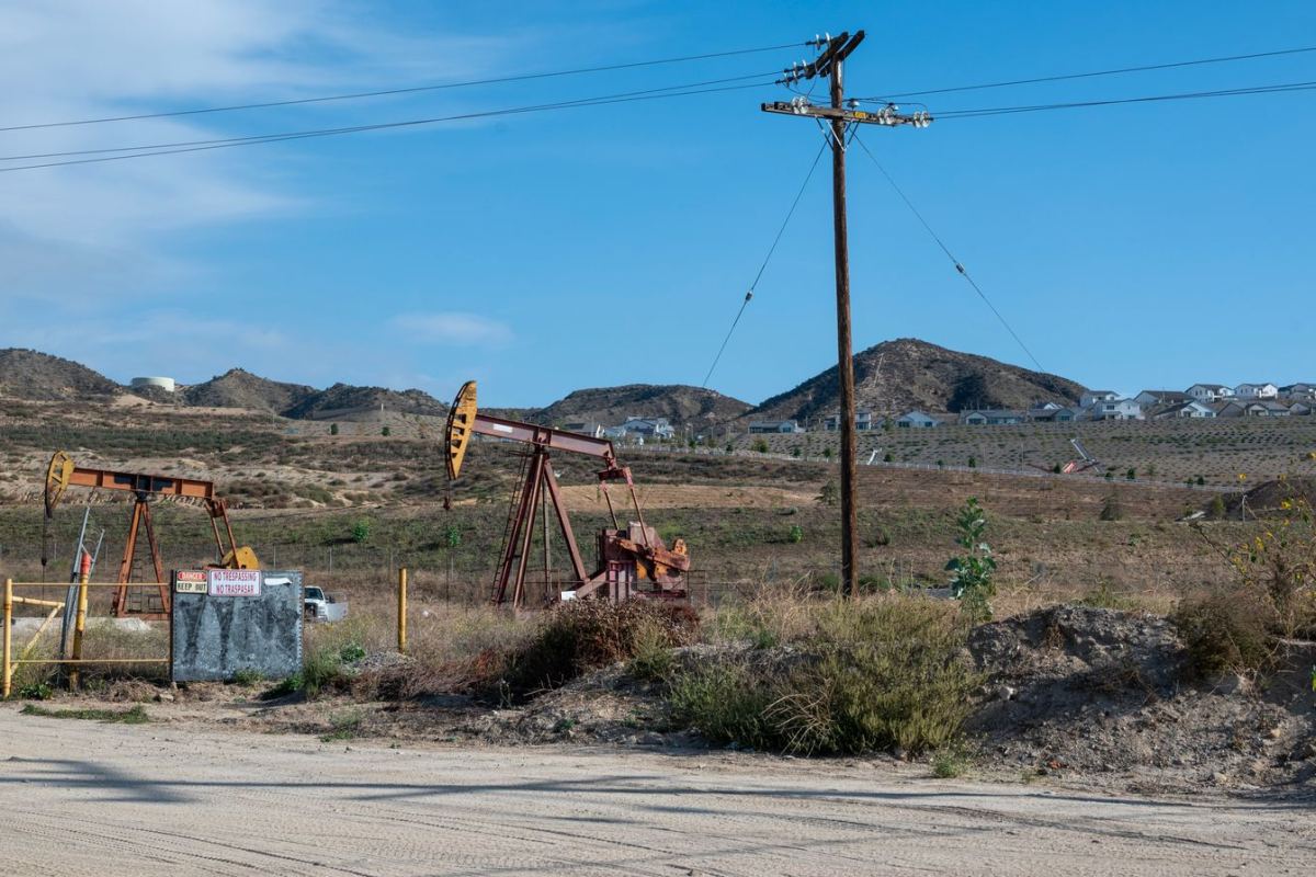 Pumpjacks among hills and power lines