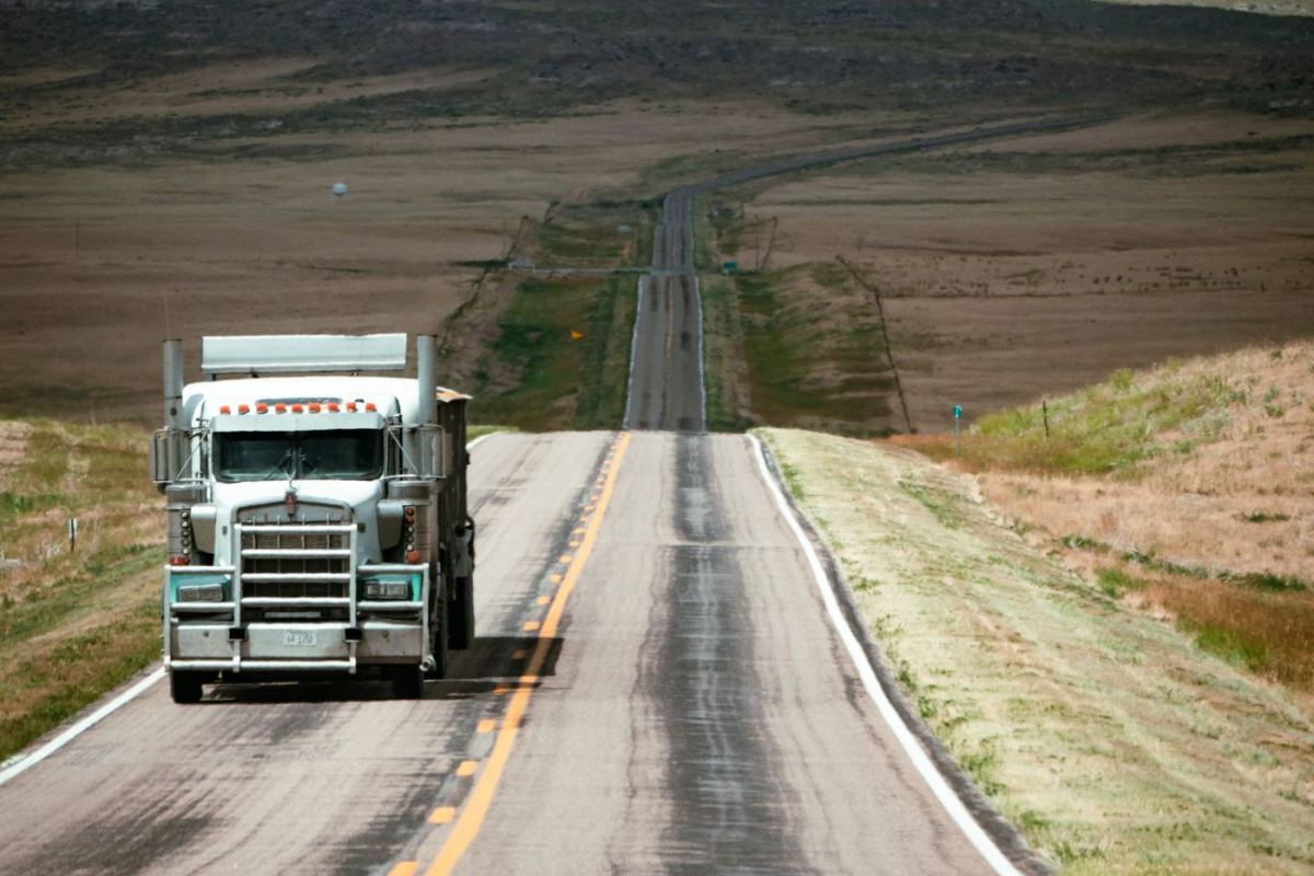 Truck on a straight road across the plains